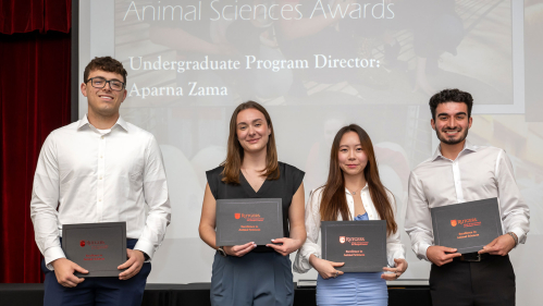 Four students holding certificates.