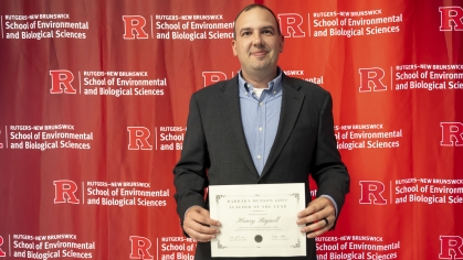 Henry Bignell holding a certificate.