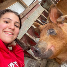 Sarah Van Name with a pig.